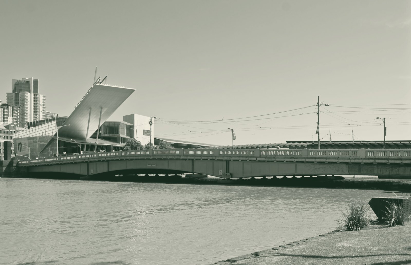a bridge over a body of water with buildings in the background