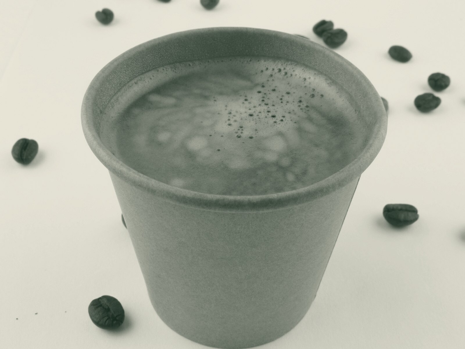 a cup of coffee sitting on top of a table